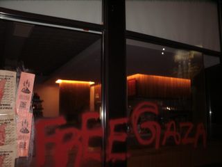"Free Gaza" in red spray paint on store window.