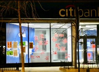 Solidarity messages and paint on the windows of a Lincoln Park Citibank location.