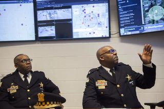 Kevin Johnson (right), then Commander of CPD’s 11th District, pictured demonstrating ShotSpotter technology in March 2017. Photo Credit: Maria Cardona/Sun-Times