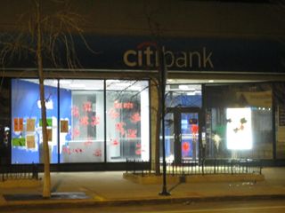 Paint splatters in colors of the Palestinian flag across the Citibank door. 